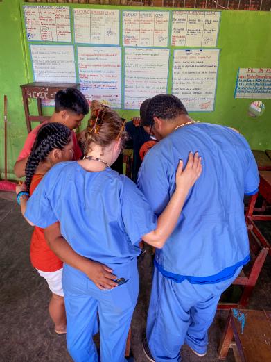 Students praying with patients 