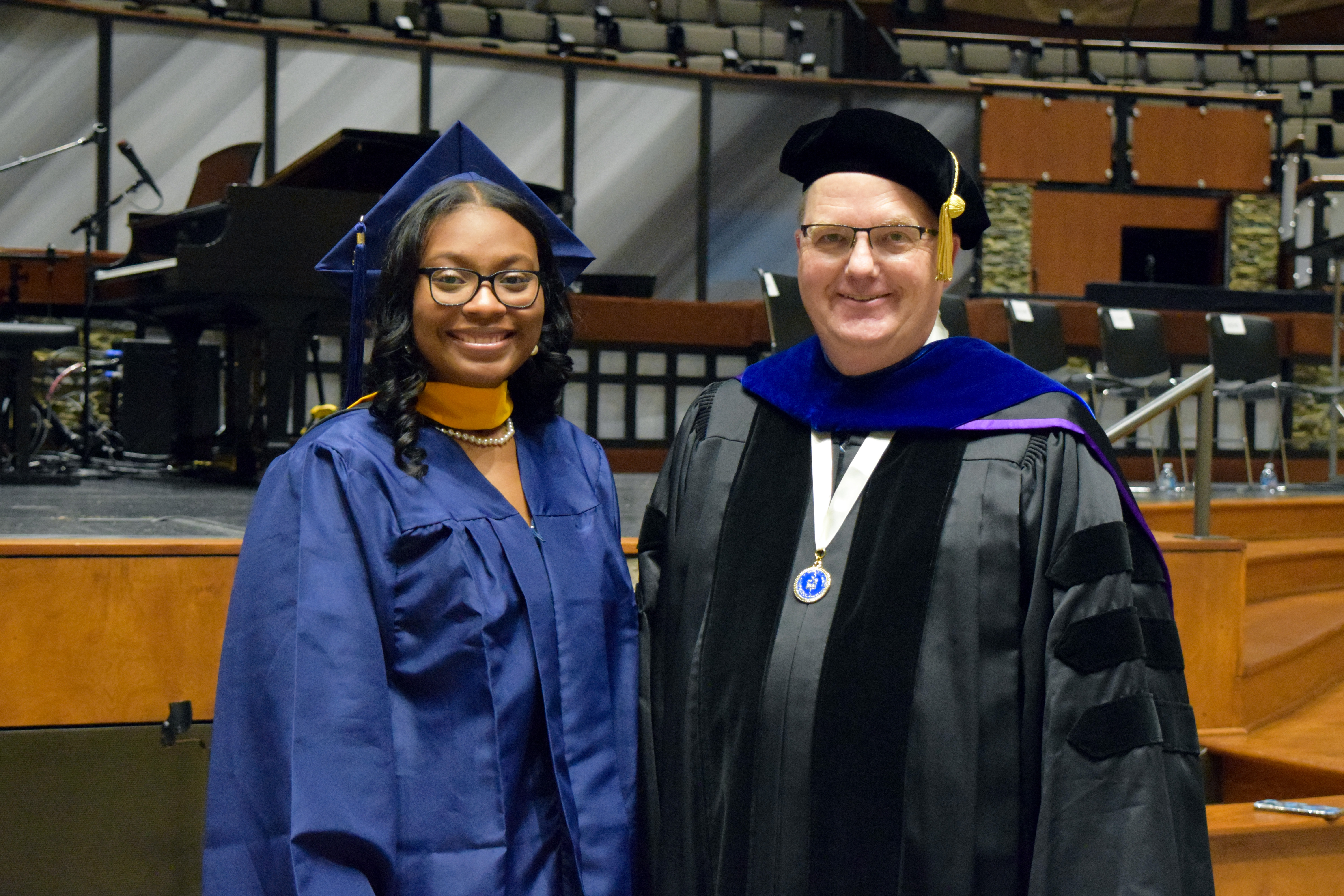 student posing with professor 