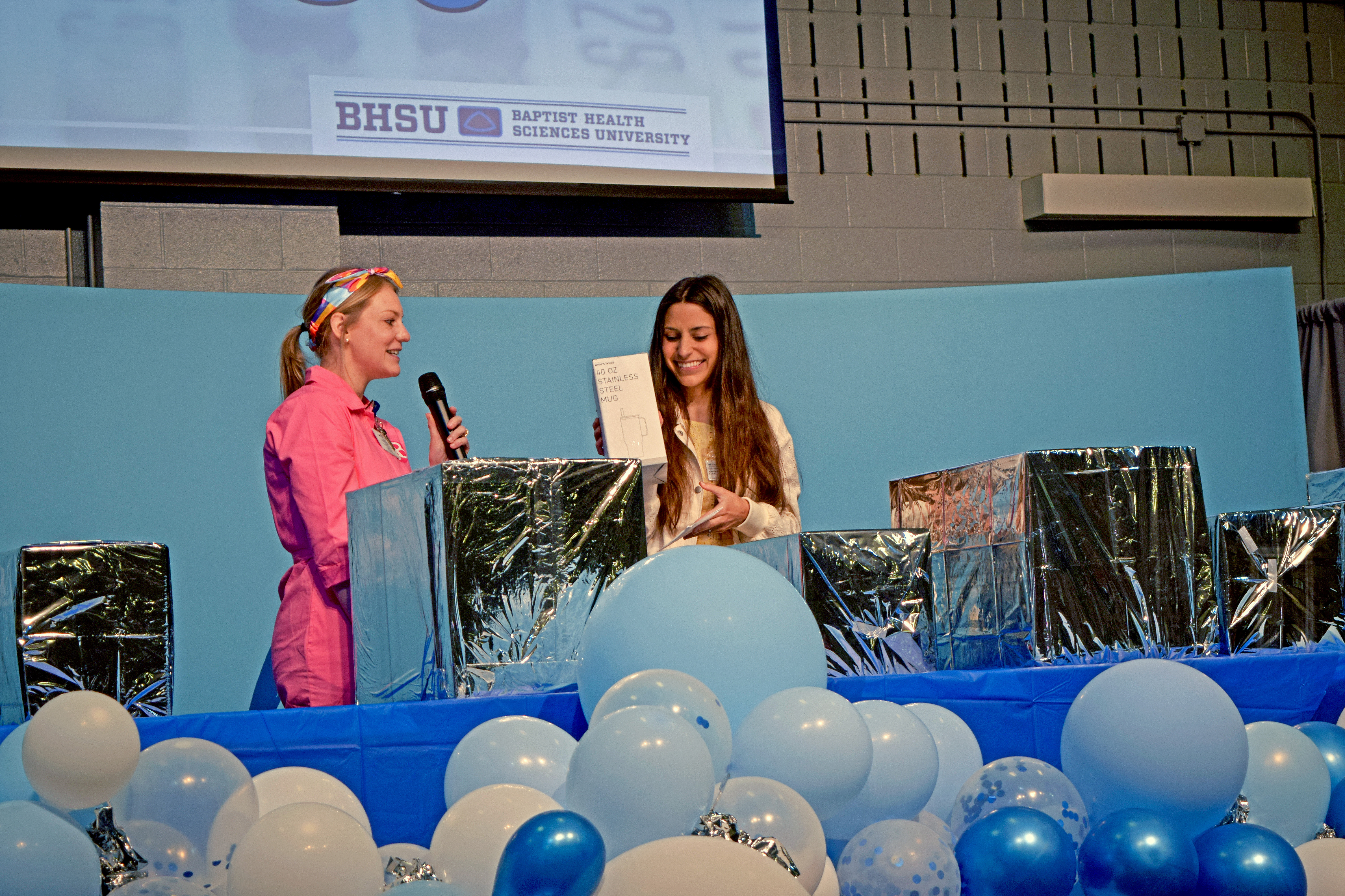 Student transitions coordinator holding gift