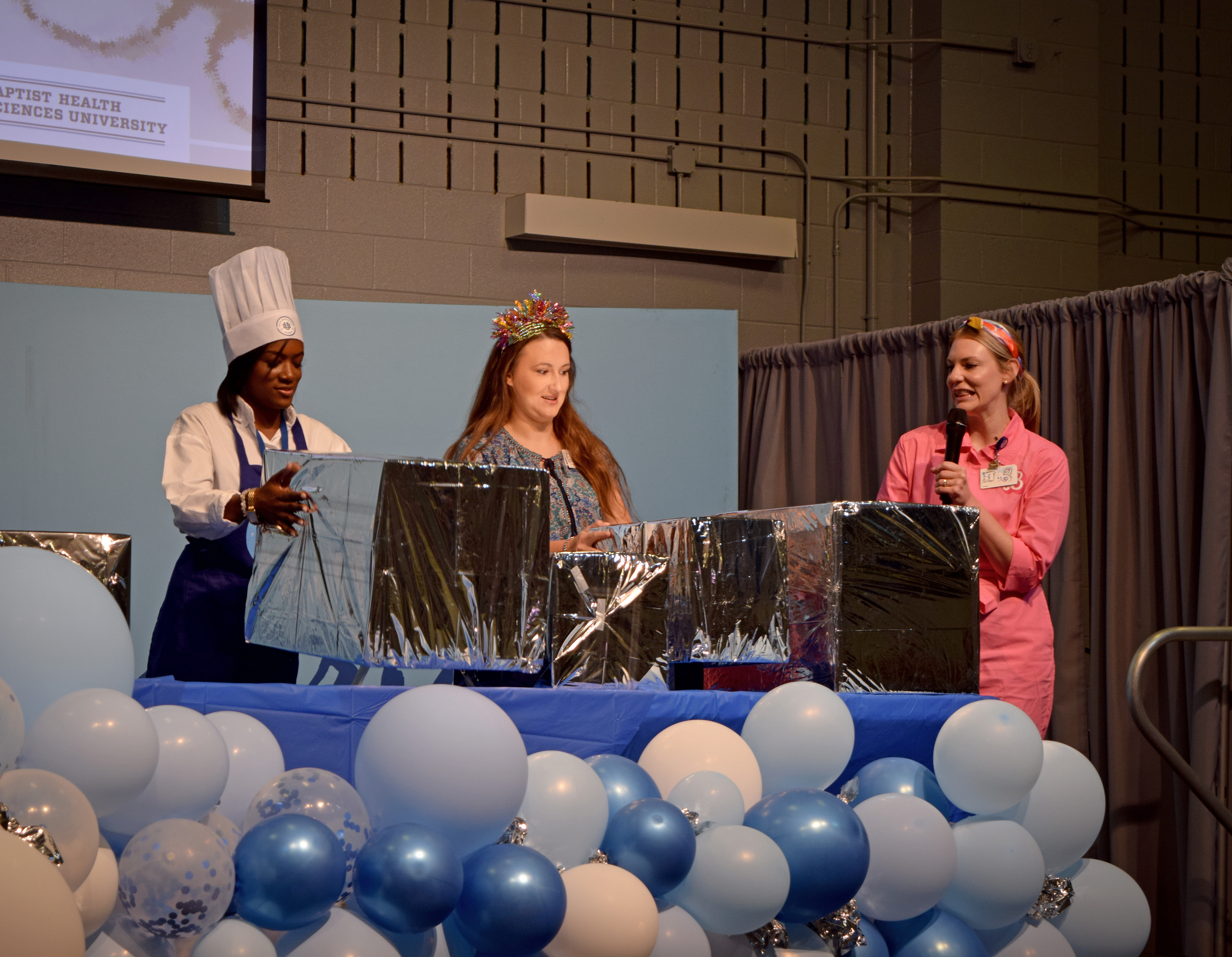 Digital Marketing coordinator with the chef hat and Clinical Coordinator with the headband opening boxes