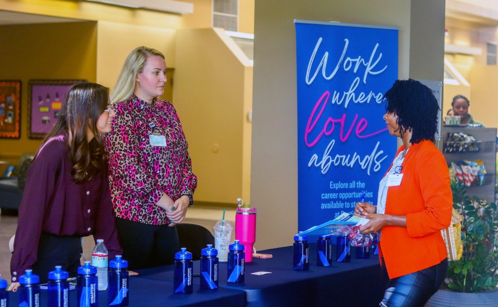 Student at Baptist Employment Services Table