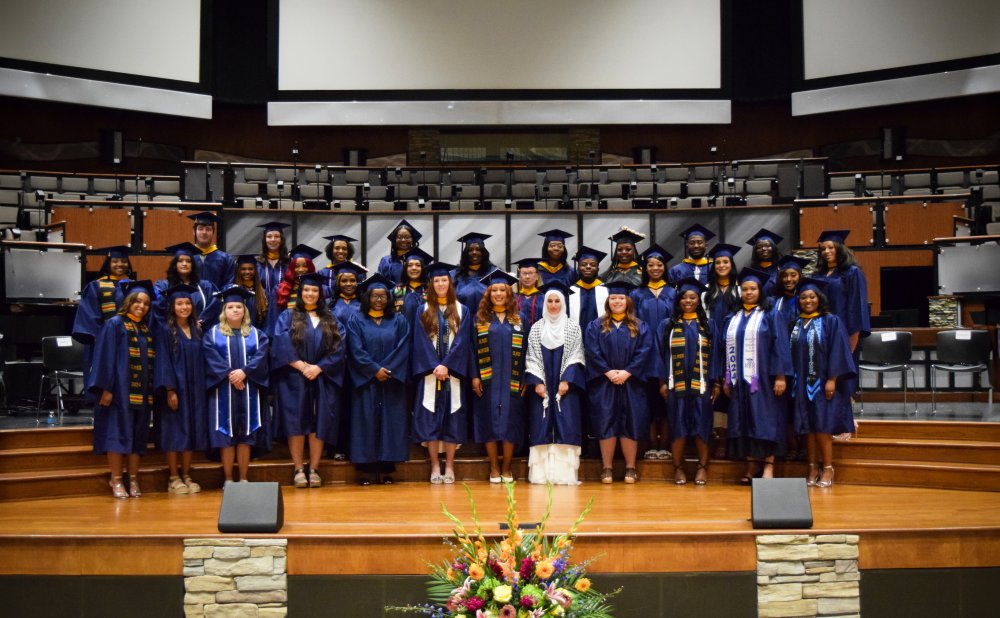 The class of August 2024 graduates posing for a group photo