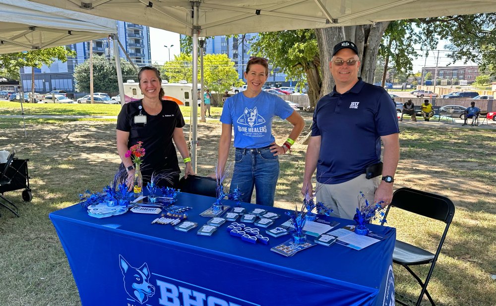 three directors standing behind bhsu table at the mmdc festival 