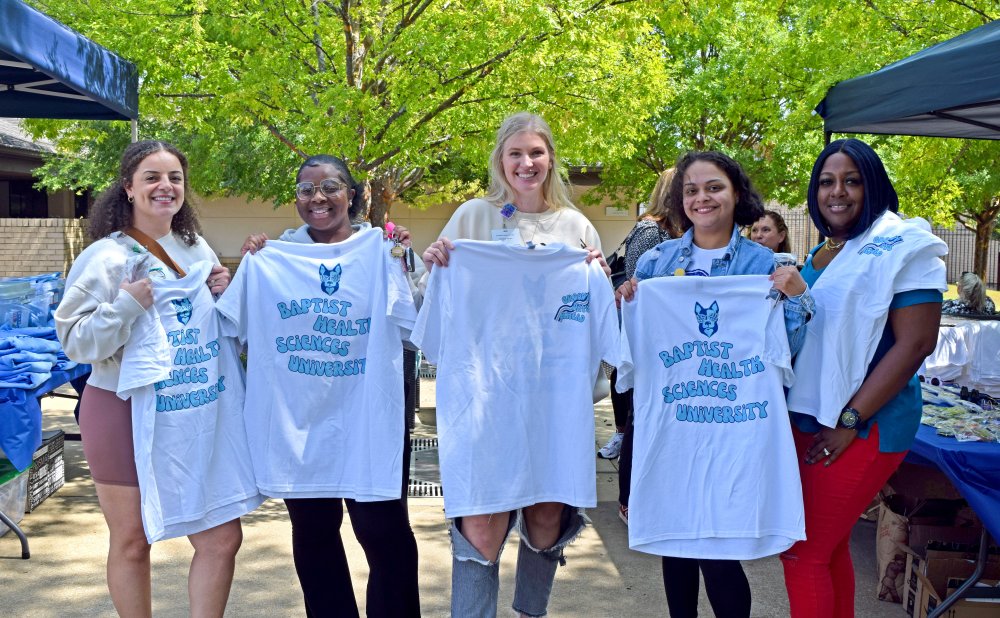 students holding welcome week tshirts 