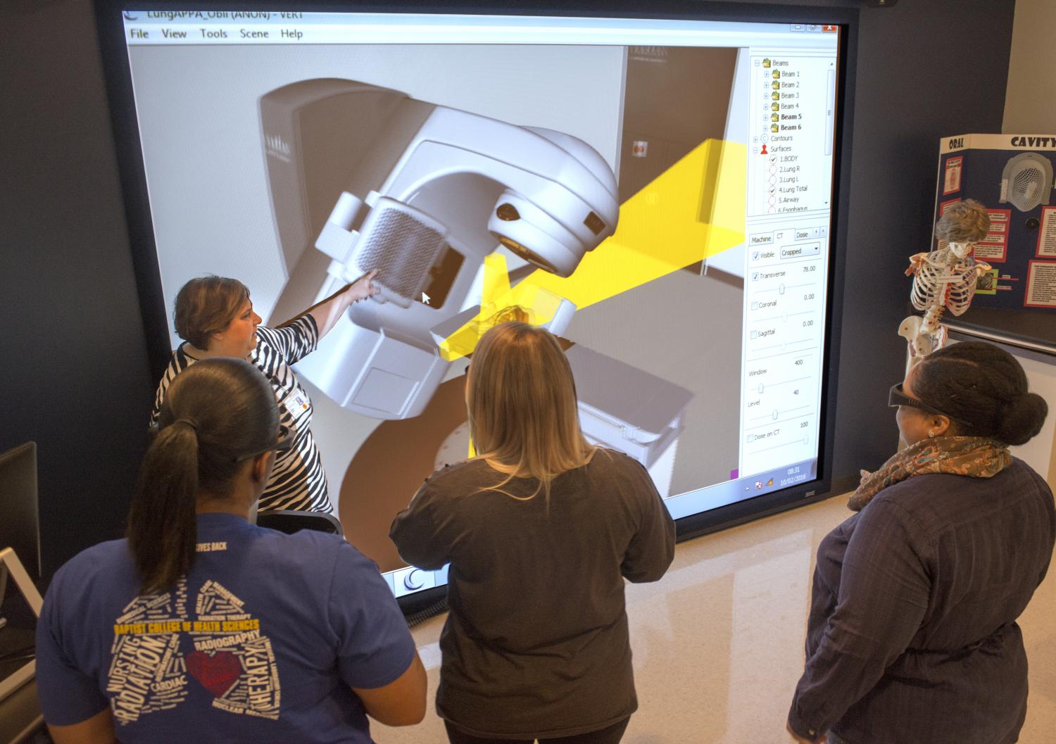 Students looking at VERT treatment simulator