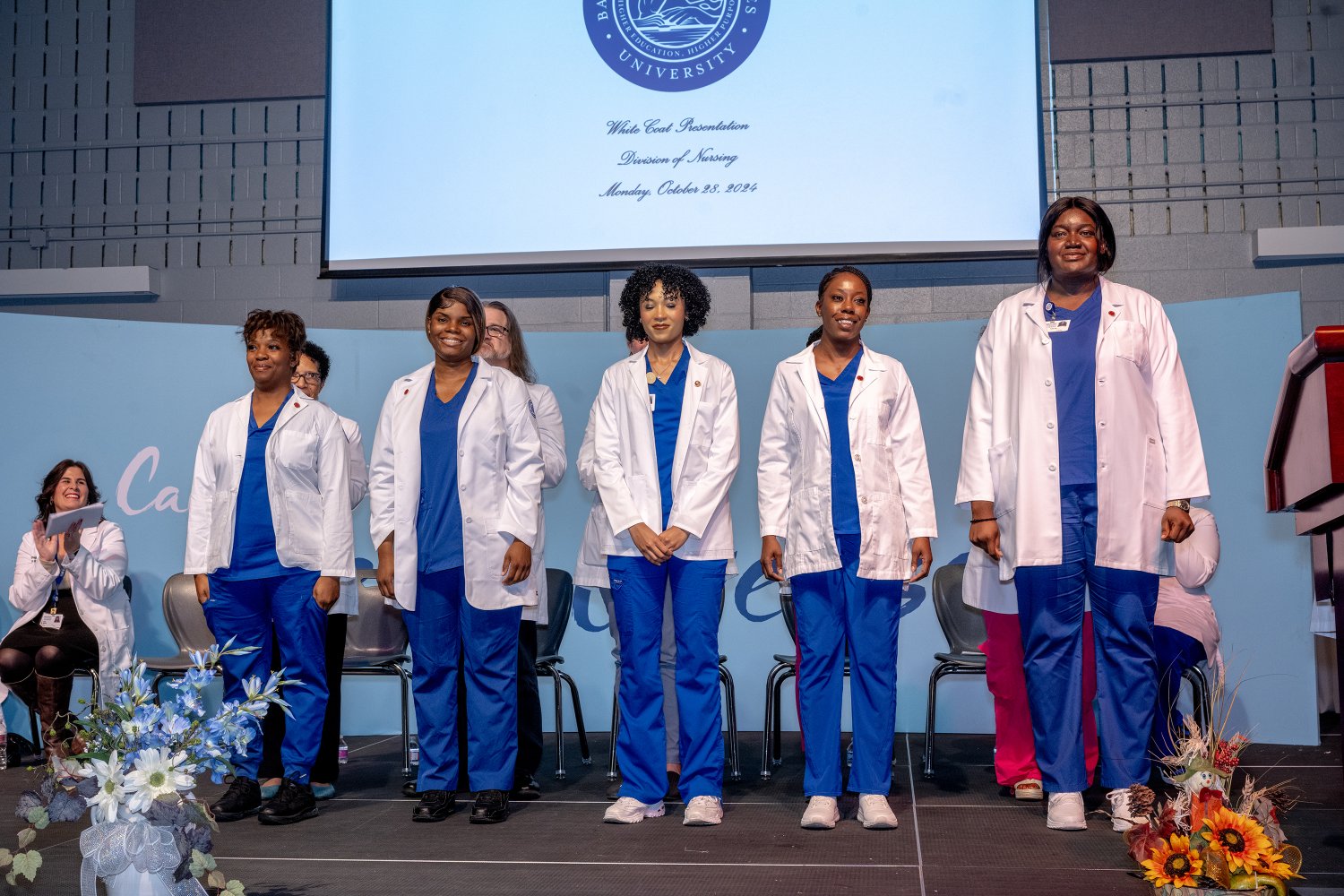 5 students receiving their white coats