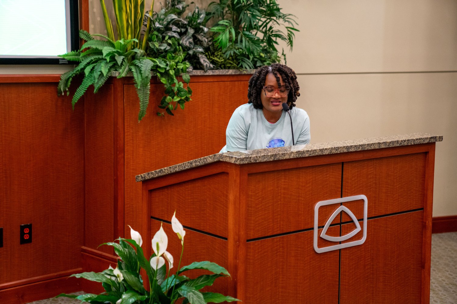 Professor Lilian Nyindodo behind a brown podium with the Baptist logo on it