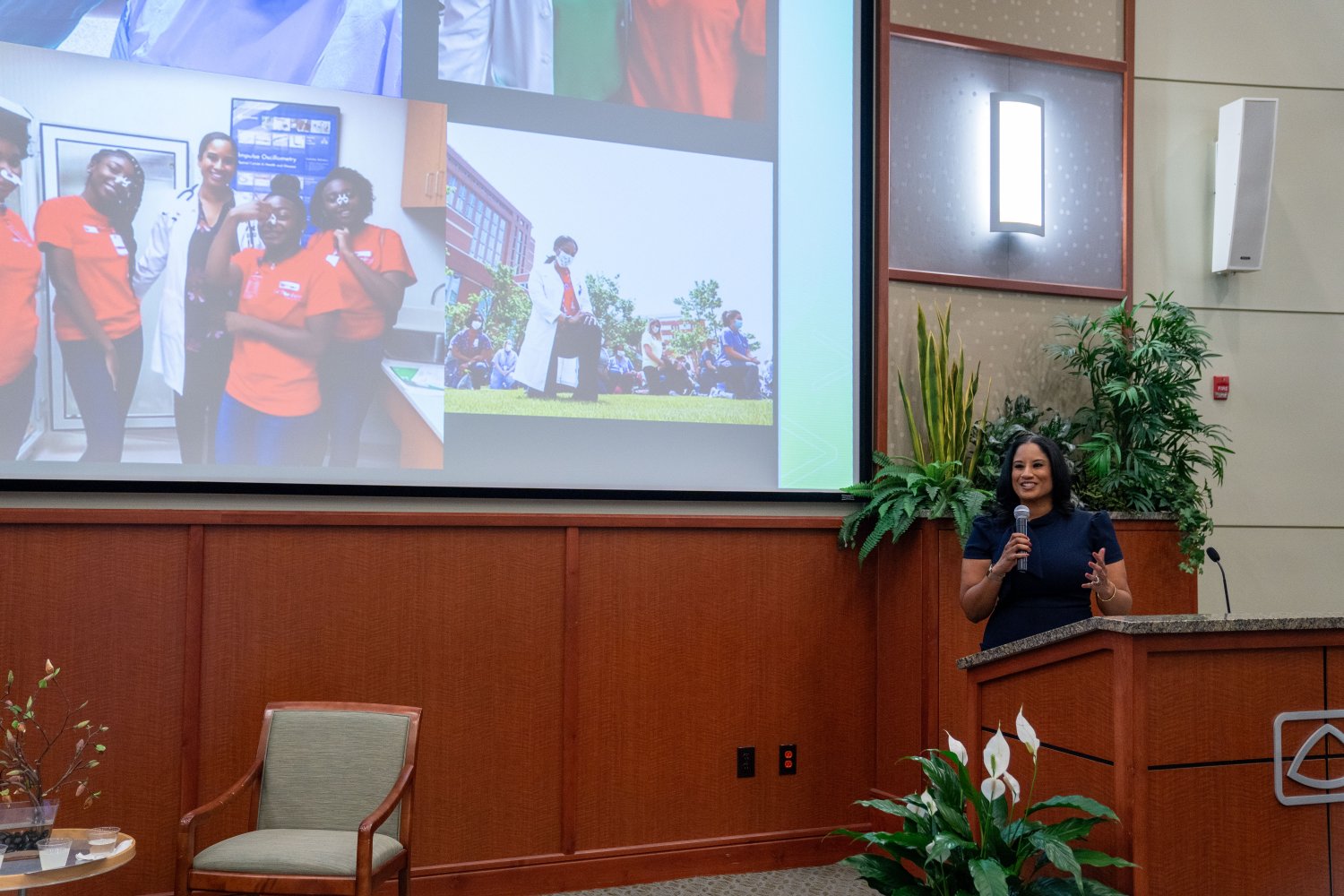 Keynote Speaker Jamila Smith-Young behind a podium that has the Baptist logo on it holding a microphone