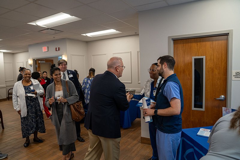 attendees talking with one another at the opening 