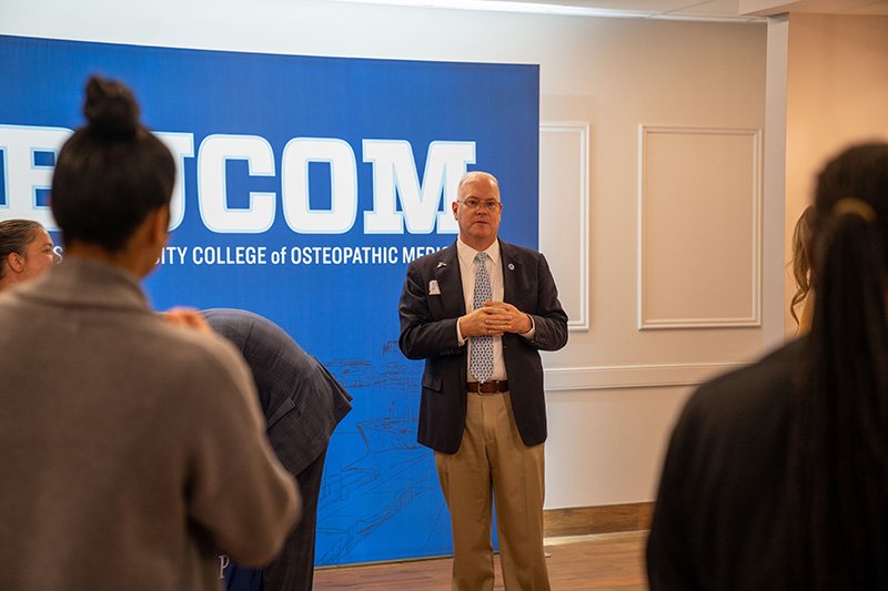 John Biery standing in front of the OMM clinic