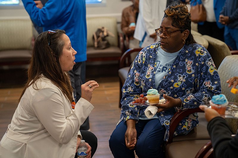 Amanda Riley talking with an attendee 