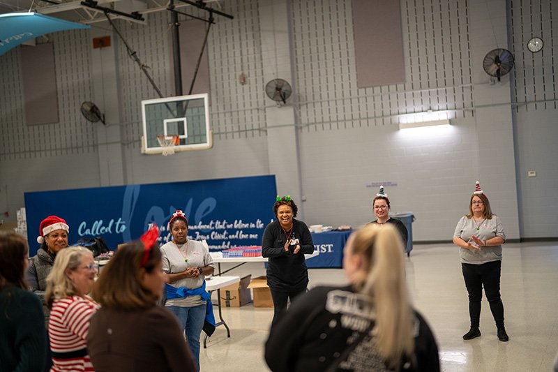 volunteers gathered in the gym packing boxes