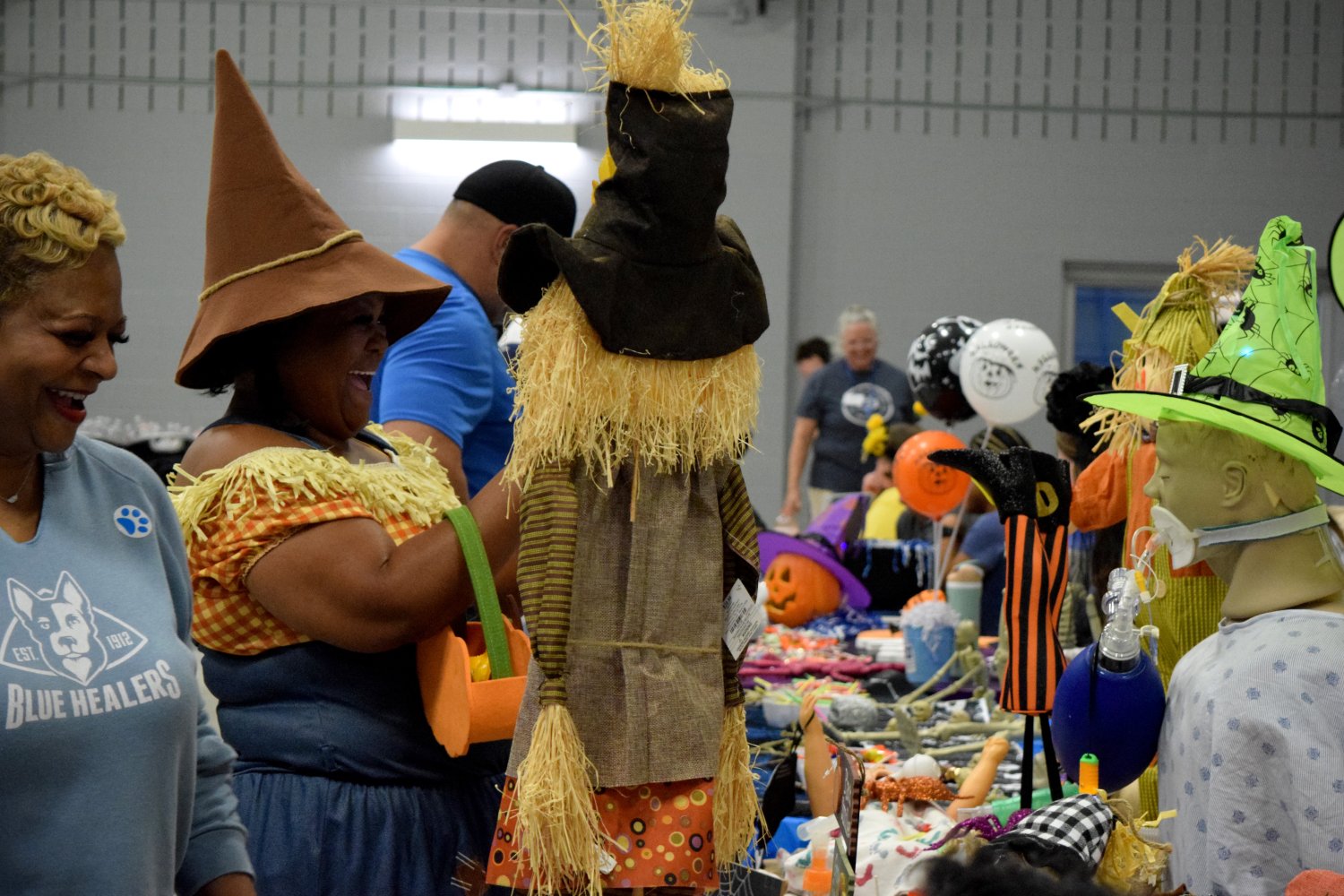 person dressed in a scarecrow outfit at a booth 