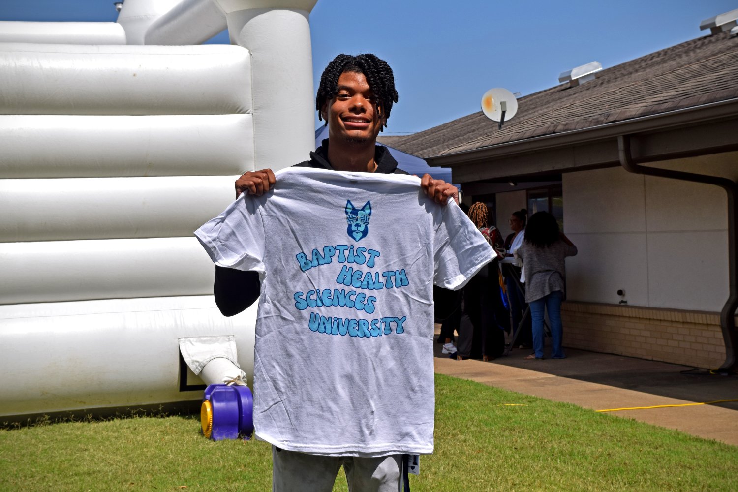 Rock the Block Party student holding shirt 