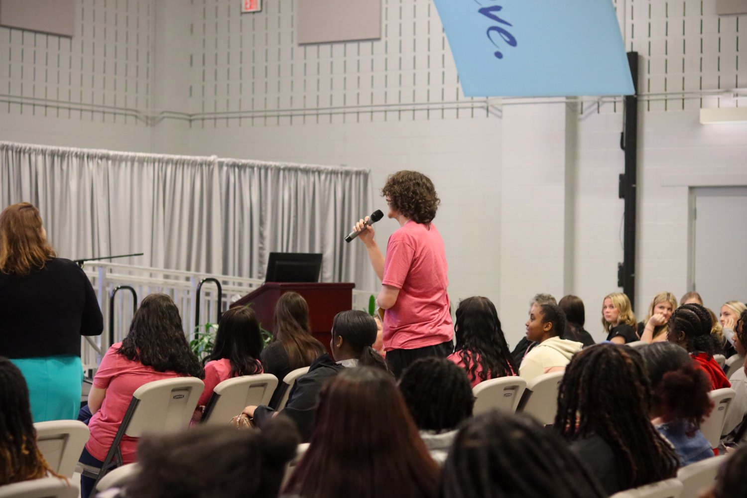 One student asking a question to the expert panel