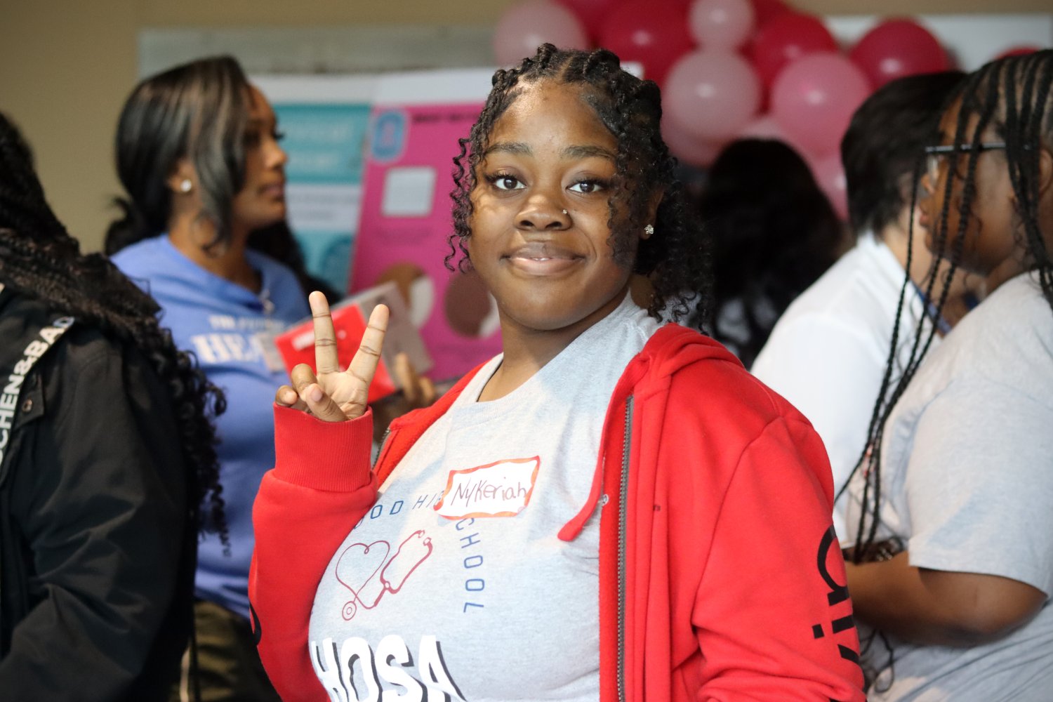 one student smiling at the camera