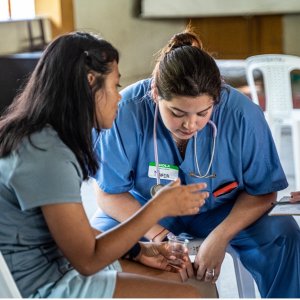 Photo of Maria Rodriguez in blue scrubs on the Peru Mission Trip 