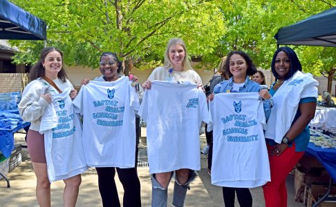 students holding welcome week tshirts 